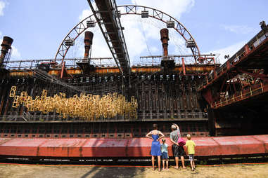 family admiring the zollverein coal mine industrial complex