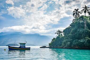 boat docked over baia carioca, paraty, brazil