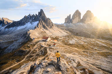 A person looking at the Three Peaks of Lavaredo and the dolomites in Italy