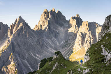 man hiking amongst dolomites landscape