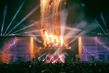 fireworks exploding at an outdooor music festival