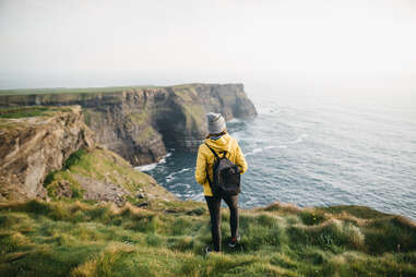 Young backpacker standing on the Cliffs of Moher